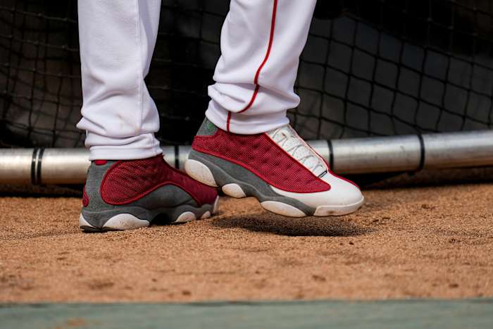 View of Elly De La Cruz's red and grey Air Jordan shoes.